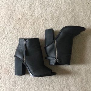 Black heeled booties with zippers on the side